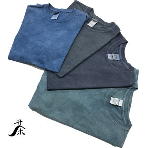 May include: Four folded t-shirts in different shades of blue. The shirts are made of a soft, comfortable fabric and have a relaxed fit.