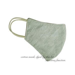 May include: A light green cotton face mask with cream-colored ear loops. The mask has a textured appearance and is designed to cover the nose and mouth. Text on the image reads "cotton mask, dyed by this kit antivirus function."