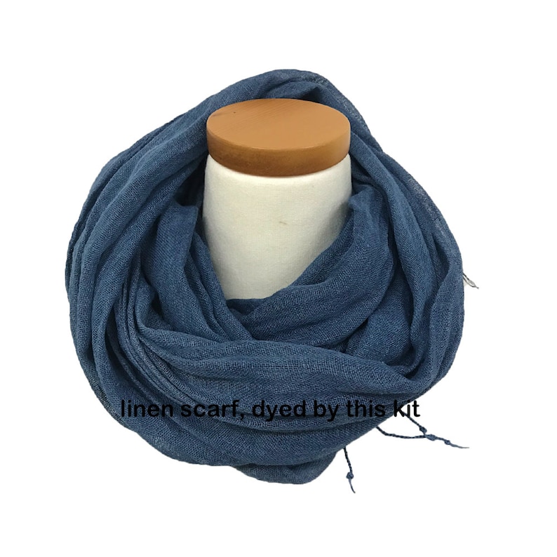 May include: A blue linen scarf, dyed by this kit. The scarf is folded and displayed on a white mannequin.