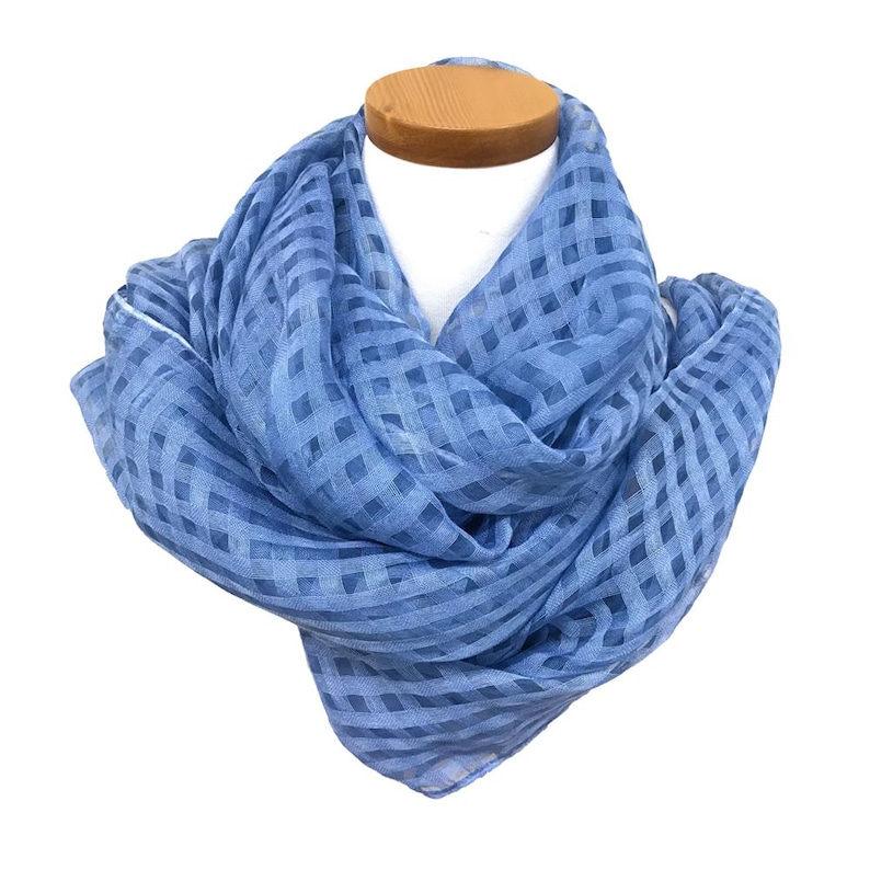 May include: A light blue scarf with a checkered pattern is draped over a mannequin head. The scarf is made of a lightweight fabric and has a soft, flowing appearance. The scarf is a solid light blue color.