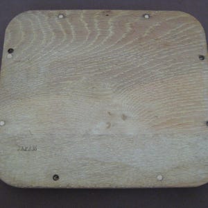 May include: A light-coloured, rectangular wooden tray with rounded corners. The wood grain is visible, and the tray has several small screw heads and the word "JAPAN" stamped on it.