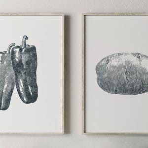 May include: Two framed prints, one with a black and white illustration of two bell peppers, the other with a black and white illustration of a potato.