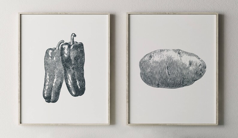 May include: Two framed prints, one with a black and white illustration of two bell peppers, the other with a black and white illustration of a potato.