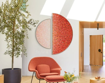May include: A living room interior with a red and pink abstract art piece on the wall, a red armchair and ottoman, a wooden coffee table, and a potted olive tree.