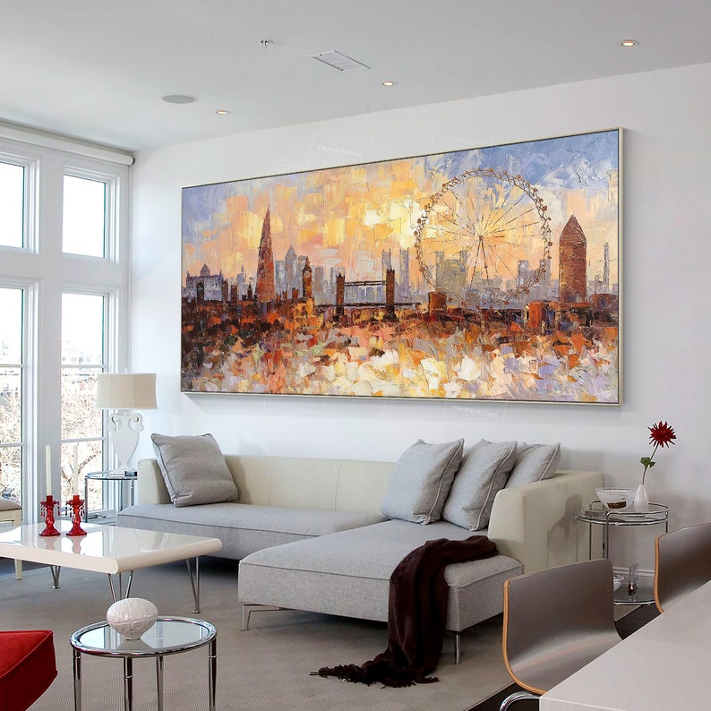 May include: A colorful abstract painting of the London skyline with the London Eye Ferris wheel in the background. The painting is done in a palette of warm colors, including yellow, orange, red, and brown. The painting is framed and hanging on a white wall in a living room.