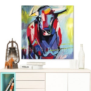 May include: Abstract painting of a bull in shades of red, blue, and yellow. The bull is depicted in a stylized, geometric style.