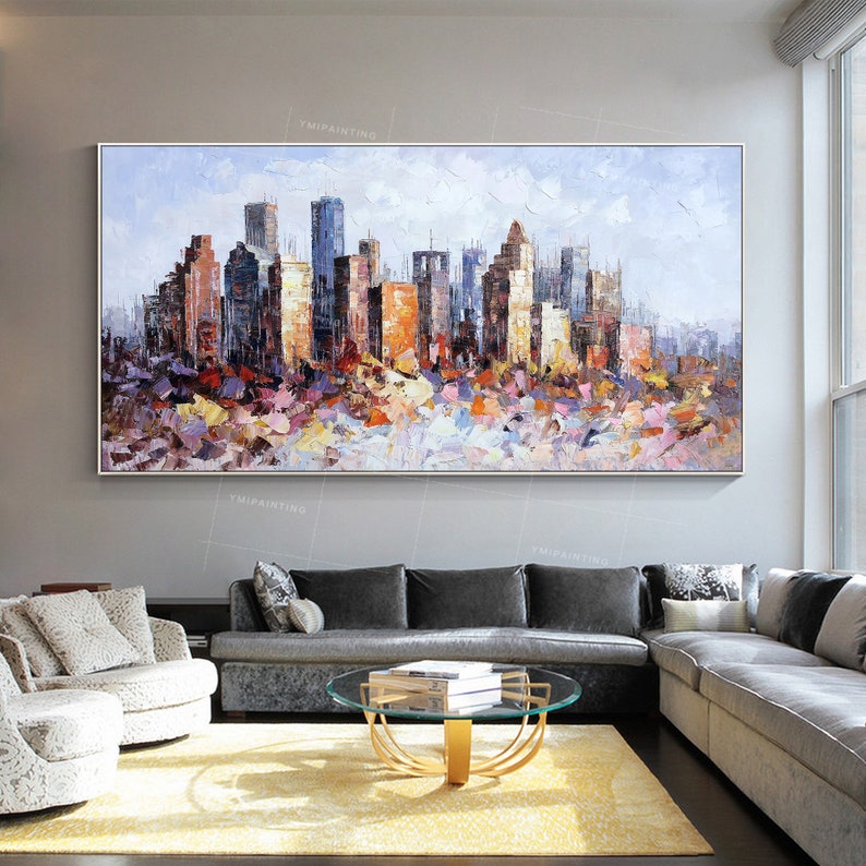 Puede incluir: Una pintura abstracta colorida de una ciudad con edificios en varios tonos de azul, naranja y amarillo. La pintura est&aacute; hecha en un estilo texturizado, con pinceladas visibles.