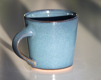 Floating blue pottery mug