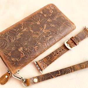 May include: A brown leather wallet with a floral embossed design, a matching brown leather watch band, and a brown leather strap.