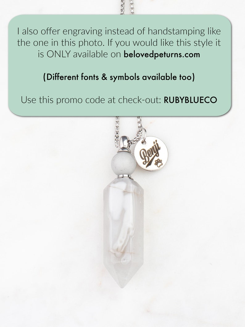 May include: A silver necklace with a white crystal pendant and a silver charm with the name "Benji" engraved on it. The necklace is on a white background. The text "I also offer engraving instead of handstamping like the one in this photo. If you would like this style it is ONLY available on belovedpeturns.com (Different fonts & symbols available too) Use this promo code at check-out: RUBYBLUECO" is at the top of the image.