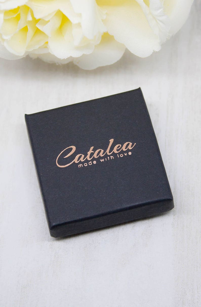 May include: A black box with the text "Catalea made with love" in rose gold lettering.