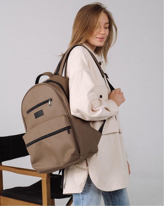 beige backpack purse