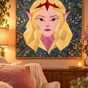 May include: A square fabric wall hanging featuring a geometric, pieced quilt design of a blonde elf with pointed ears and a red crown. The background consists of dark blue fabric with a floral pattern, framed in a thin wooden border.