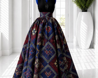 May include: A sleeveless black bodice dress featuring a high-waisted, floor-length skirt. The skirt is made of a structured fabric with a repeating geometric diamond pattern in shades of deep blue, dark red, and gold, creating a full silhouette.