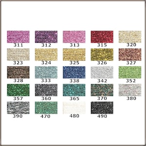 May include: A colour chart displaying twenty-four rectangular swatches of metallic glitter thread. Each swatch is labelled with a numerical code ranging from 311 to 490, showcasing a variety of colours including pink, purple, gold, silver, green, blue, and black.