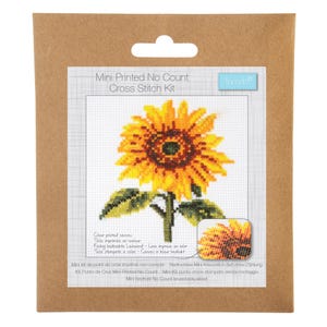 May include: A cross-stitch kit with a sunflower design. The kit includes a printed canvas with a detailed image of a sunflower in full bloom, showcasing yellow petals and a dark brown center. The packaging includes the text "Mini Printed No Count Cross Stitch Kit."