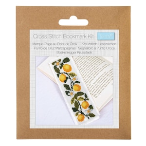 May include: A Cross Stitch Bookmark Kit by Trimits in brown packaging. The kit features a white fabric bookmark with a cross-stitched pattern of yellow lemons, green leaves, and small white flowers, displayed resting on an open book page.