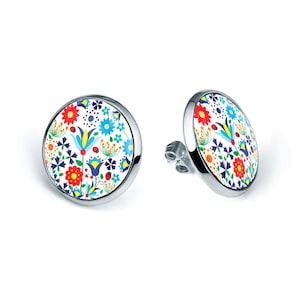 May include: A pair of silver stud earrings with a round white background and a colorful floral pattern. The pattern includes red, yellow, blue, green, and orange flowers, leaves, and ladybugs.