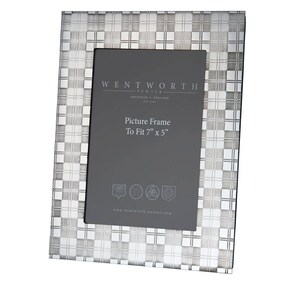 May include: A silver picture frame with a checkered pattern. The frame is made by Wentworth Pewter and is designed to fit a 7 inch by 5 inch picture. The frame has the text "Wentworth Pewter, Sheffield England" and "Picture Frame To Fit 7" x 5" printed on it.