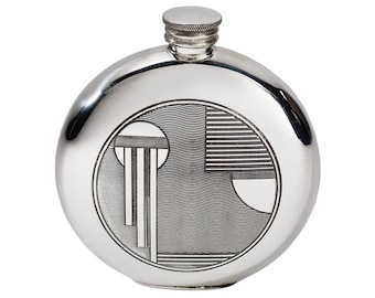 May include: A silver round hip flask with a geometric design engraved on the front.