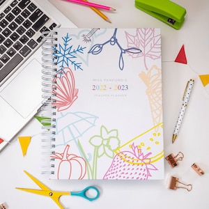 White wire bound Teacher planner with various icon drawings, strawberry, flower, butterfly, snowflake, ice cream and a snowflake. 2 sizes, A4 & A5, choice of colour in the wires and  ribbons.