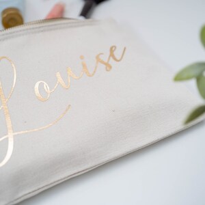 Cream cotton canvas make up bag with a sturdy zip and  personalisation in gold foil.