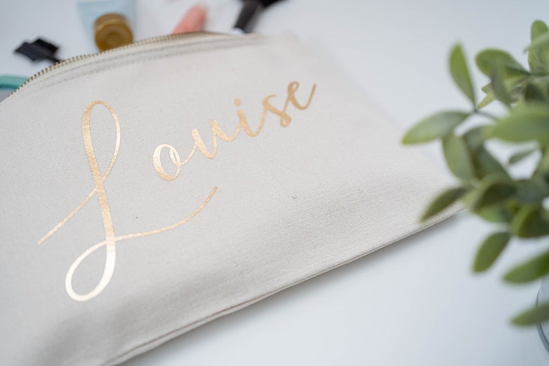 Cream cotton canvas make up bag with a sturdy zip and  personalisation in gold foil.