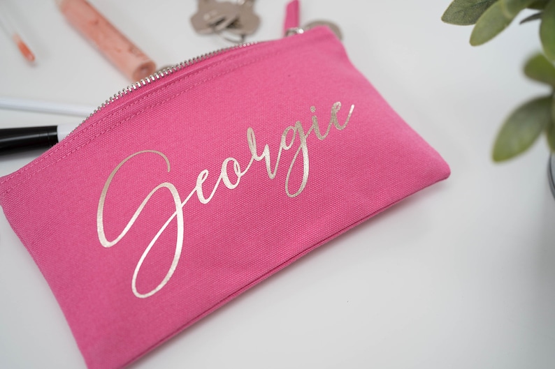 Pink cotton canvas make up bag with a sturdy zip and  personalisation in a silver foil.
