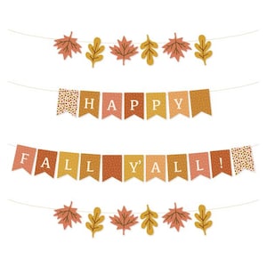 May include: A festive fall banner with the words "HAPPY" and "FALL Y'ALL" displayed on pennant flags. The banner features autumn-themed leaf cutouts in shades of orange, yellow, and brown, perfect for seasonal decorations.