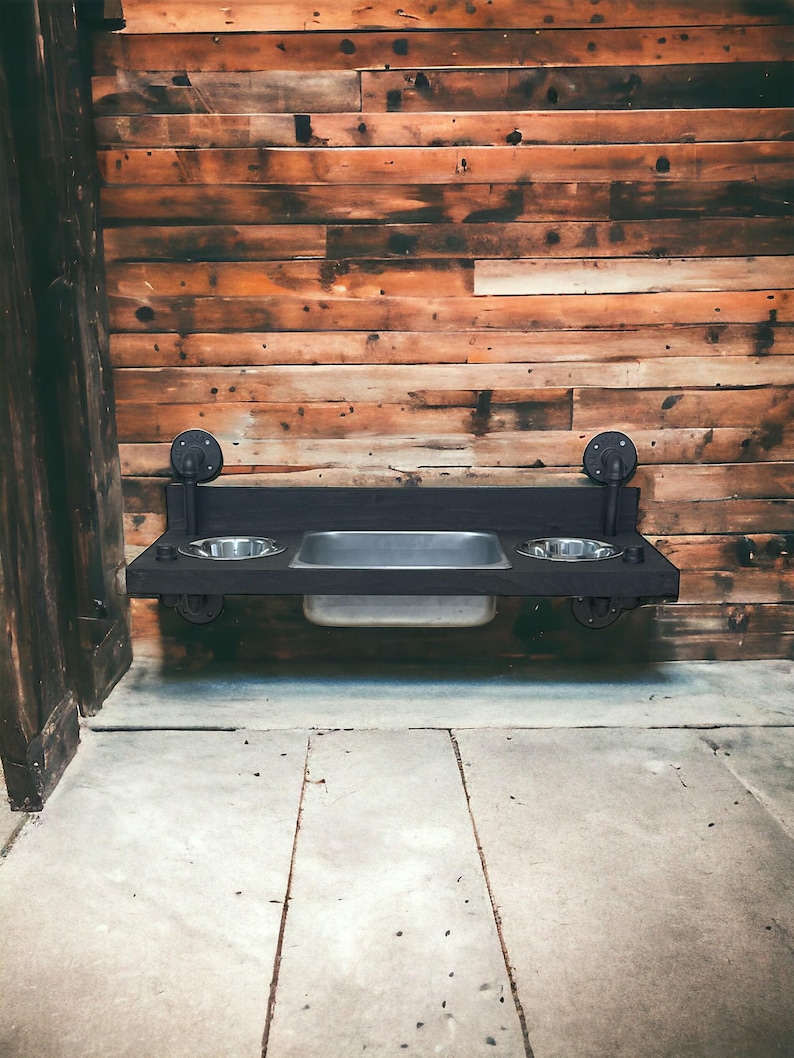 Floating water bin dual feeder: steampunk pet feeding station with two stainless bowls on a wooden platform beside a dog.