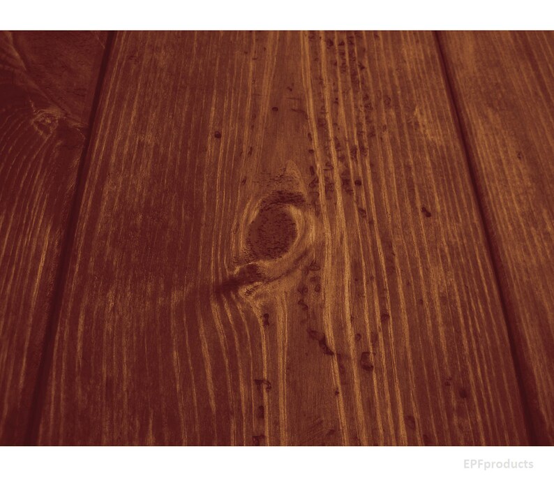 May include: Close-up of a dark brown wood grain surface with a knot in the center. The wood has a natural, rustic look.