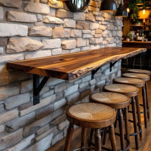 May include: A long, live-edge wooden bar counter mounted to a stone wall with black metal brackets, accompanied by a row of four round wooden bar stools featuring woven seats and dark brown legs arranged in a line along the counter surface.