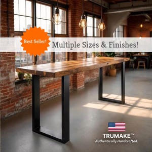 May include: A rectangular wooden table with a dark finish and black metal legs. The table is labeled "Best Seller! Multiple Sizes & Finishes!" and "TRUMAKE Authentically Handcrafted."