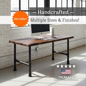 May include: A rectangular wooden desk with a dark brown finish and black metal pipe legs. The desk surface holds a computer monitor, keyboard, and mouse. Text on the image reads: Handcrafted, Multiple Sizes & Finishes!, Best Seller!, TRUMAKE.