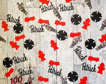 May include: 100 pieces of confetti featuring a firefighter theme. The confetti includes red fire trucks, black fire hydrants, black firefighter helmets, and the name Patrick in black script.