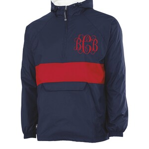 May include: A navy blue windbreaker with a red stripe across the chest. The windbreaker has a zipper and a hood. The letters "BGB" are embroidered on the chest in red.