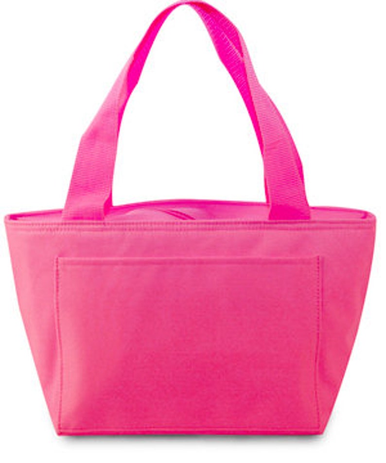 May include: A bright pink insulated tote bag with a rectangular front pocket and matching pink handles. The bag has a zippered top closure and is designed to keep items cool. The tote is made of a durable, water-resistant material.