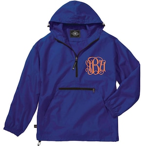 May include: A royal blue hooded pullover jacket with a black zipper and a black pocket. The jacket has an orange monogram on the front.