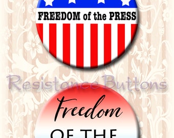 May include: Two round buttons with red, white, and blue designs. The top button has a blue background with white stars and red and white stripes. The text "FREEDOM of the PRESS" is printed in black on the button. The bottom button has a red, white, and blue gradient background with the text "Freedom OF THE PRESS" printed in black.