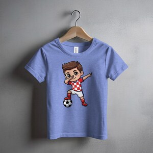 Cartoon boy in Croatian soccer jersey dabbing with ball.