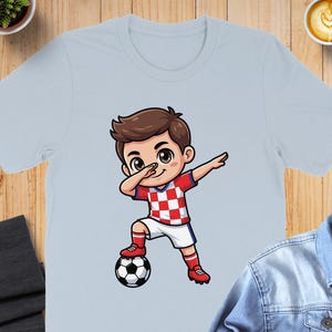 Cartoon boy in Croatia soccer uniform dabbing with a soccer ball.