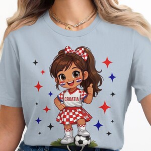 Cartoon girl in Croatia soccer uniform with checkerboard pattern, giving thumbs up.