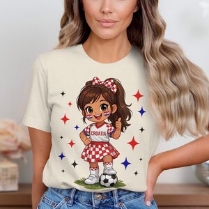 Cartoon girl in Croatia soccer uniform with thumbs up and soccer ball.