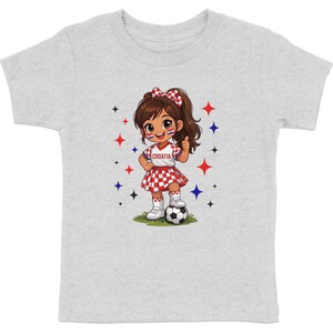 Cartoon girl in Croatia outfit with soccer ball, thumbs up.