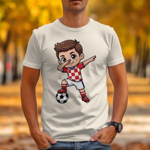 Cartoon soccer player dabbing on a white t-shirt with a blurred autumn background.