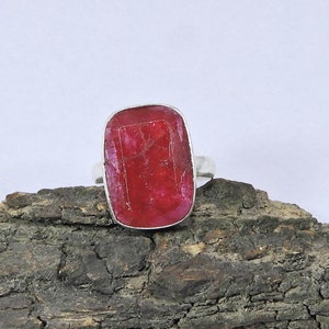 Puede incluir: Un anillo de plata con una gran piedra preciosa rectangular roja.