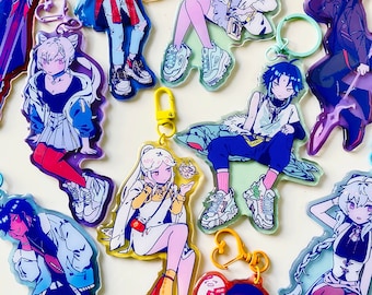 May include: A set of 10 colorful anime character keychains. Each keychain features a different character with unique clothing and accessories. The keychains are made of clear acrylic and have a metal ring for attaching to keys or bags.