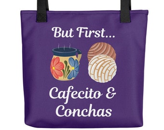 May include: Purple tote bag with black handles. The bag has white text that reads "But First... Cafecito & Conchas". There is an illustration of a coffee mug and two pastries.