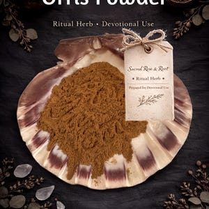 May include: A brown powder, labeled "Orris Powder," is displayed in a large shell. The shell rests on a dark surface, with a tag tied to it that reads "Sacred Rose & Root" and "Ritual Herb." The image has a spiritual or ritualistic theme.