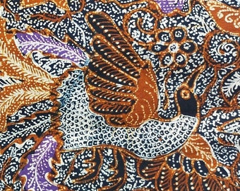 May include: A brown, white, and purple batik fabric with a floral and bird pattern.